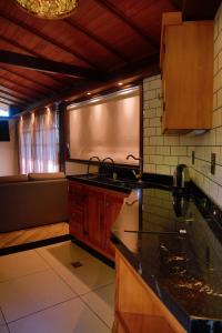 a kitchen with a stove and a counter top at Minas Em Marambaia in Rio de Janeiro