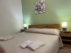Ένα ή περισσότερα κρεβάτια σε δωμάτιο στο CASA AI TRE CAMPANILI