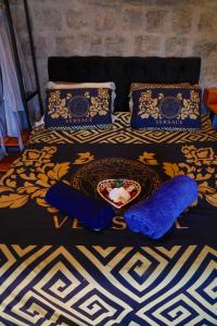 a bed with blue pillows and a plate of food on it at Minas Em Marambaia in Rio de Janeiro