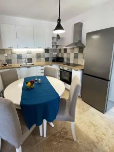 a kitchen with a table with a blue table cloth on it at Odysseus Boutique Apartment in Ermioni