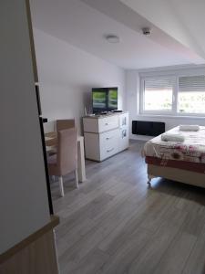 Postel nebo postele na pokoji v ubytování Apartman UNA