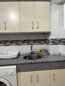 a kitchen with white cabinets and a sink at La casita de mi abuela in Santo Domingo de la Calzada +70 photos
