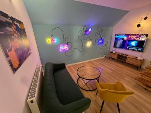 a living room with a green couch and a tv at Terminal Family Airport in Poznań +38 photos