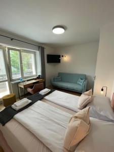 a bedroom with two large beds and a couch at Terminal Family Airport in Poznań