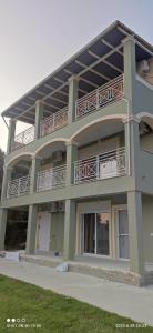 a building with balconies on the side of it at Loukas House 2 Κέρκυρα Σταυρός Μακράτα in Stavrós
