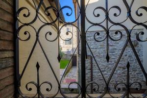 a view through an iron gate of a window at Via Mazzini 23A in Gubbio +28 photos