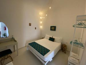 a bedroom with a bed and a desk and a mirror at Dimora Scarpa in Bari