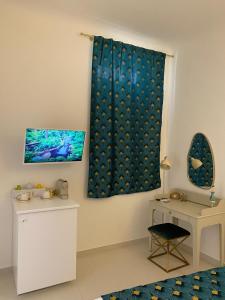a room with a blue curtain and a table at Dimora Scarpa in Bari