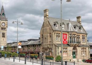 an old building with a clock tower in a city at Apartment 2 in Darlington