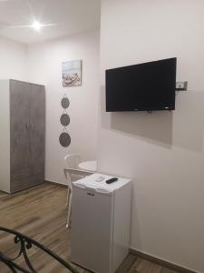 a room with a flat screen tv on a wall at Terracina Holiday Succursale in Terracina +23 photos