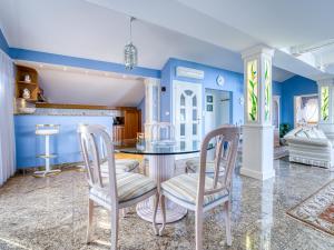 a dining room with blue walls and a table and chairs at Villa Mona Lisa Lovran - Croatia in Lovran