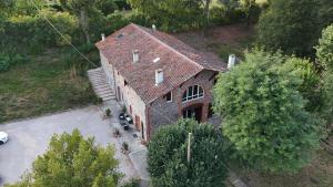 an overhead view of a large brick building with a garage at Relais DAIA in Peyssies