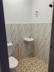 a bathroom with a toilet and a sink at Zahra homestay in Seremban