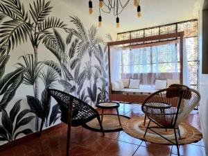 a living room with chairs and a bed in a window at Tropicalme Pamandzi in Pamandzi