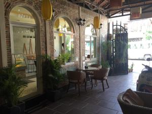 a restaurant with tables and chairs in a brick building at Comfort House in Phnom Penh