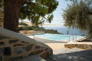 a swimming pool with a view of the ocean at Cypresses Villas in Áno Gatzéa +96 photos