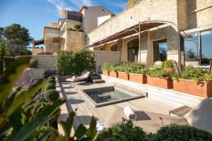 a house with a courtyard with a swimming pool at Coquillade Provence - Relais & Châteaux in Gargas