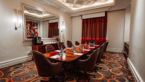 a conference room with a long table and chairs at Silverstar Hotel in Krugersdorp +33 photos