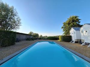 a swimming pool in the yard of a house at Casa-Cosi, tourist & business suites & flats with reserved parking and private terraces in shared garden with seasonal pool included, private sauna available in Lokeren