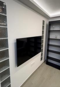 a living room with a flat screen tv on a wall at Apartman Meljine, Opština Herceg Novi in Meljine