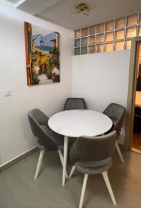 a dining room with a white table and chairs at Apartman Meljine, Opština Herceg Novi in Meljine