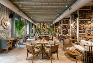 a restaurant with tables and chairs in a room at Ecole St. Pierre Hotel in Istanbul