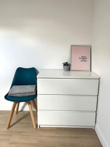 a chair sitting next to a dresser with a box on it at 731 Joli studio mezzanine proche du métro L9 in Bagnolet