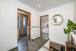 a bathroom with a glass door and a mirror at SUPER Camacha - Casa da Eira in Camacha +47 photos
