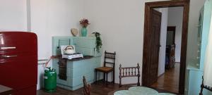 a room with a dresser and a chair and a refrigerator at Pokoje Gościnne in Przemyśl