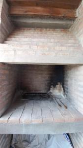 a brick oven with a brick wall at Casa Altos del Faro in Viedma