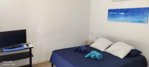 a bedroom with a bed with blue slippers on it at La Hispañola in El Campello +4 photos
