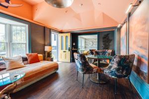 a living room with a couch and a table at Ellery Hotel Provincetown in Provincetown