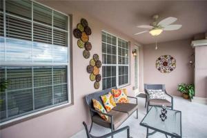 a living room with two chairs and a table at The Epic Boca Penthouse Vista Cay Orlando in Orlando