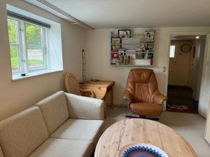 a living room with a couch and a chair and a table at Herning midtby in Herning