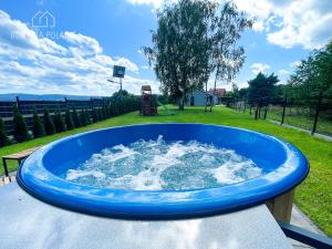a blue tub filled with water in a playground at Domy na polanie- Szarotka in Wolany