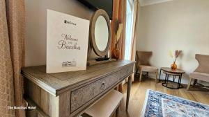a dressing table with a mirror on top of it at Bacchus Hotel in Sutton on Sea