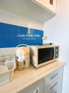 a kitchen counter with a microwave and a mixer at 2BR Comfy Family Suite Hat Yai in Hat Yai +19 photos