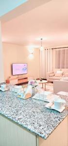 a living room with a counter top with a table at Golden Touch Luxury Superior in Nairobi