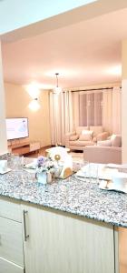 a kitchen with a counter top and a living room at Golden Touch Luxury Superior in Nairobi +37 photos