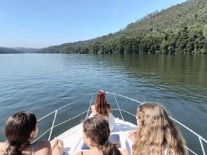 a group of women on a boat on a lake at Sunset River in Figueira da Foz