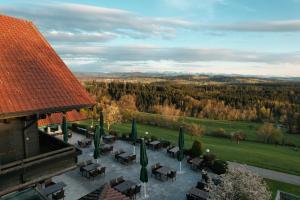 an aerial view of a patio with tables and green umbrellas at Berghotel Jägerhof ****S in Isny im Allgäu
