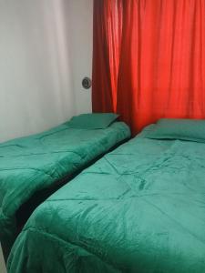 two beds sitting next to each other in a room at Terminal Dpto Estación Central Equipado in Santiago