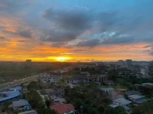 a city skyline with a sunset in the background at Manhattan Suite ITCC by 8Avenue in Kota Kinabalu