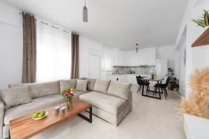 a living room with a couch and a table at G Berdufi 2 bd with parking in Eloúnda in Elounda