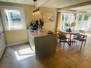 a kitchen and dining room with a table and chairs at Hausboot direkt auf der Weser in Hameln