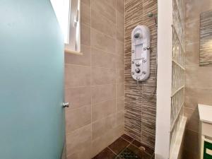 a bathroom with a shower with a phone on the wall at Sea View 2-beds 'Estrela' Apartment - Praia da Luz in Luz +15 photos