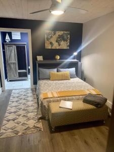 a bedroom with a large bed and a rug at Legacy Barn on Sugar Creek in Bentonville