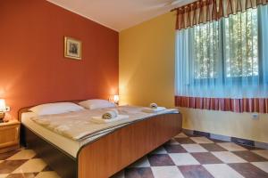 a bedroom with a bed with two towels on it at Villa Emilia in Banjole