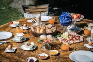 a wooden table with food on top of it at Mirabelle Pension Sankt Ursula in Saltusio +29 photos