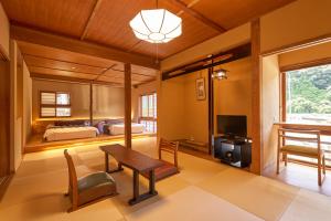 Voodi või voodid majutusasutuse Arifuku Onsen Yoshidaya toas